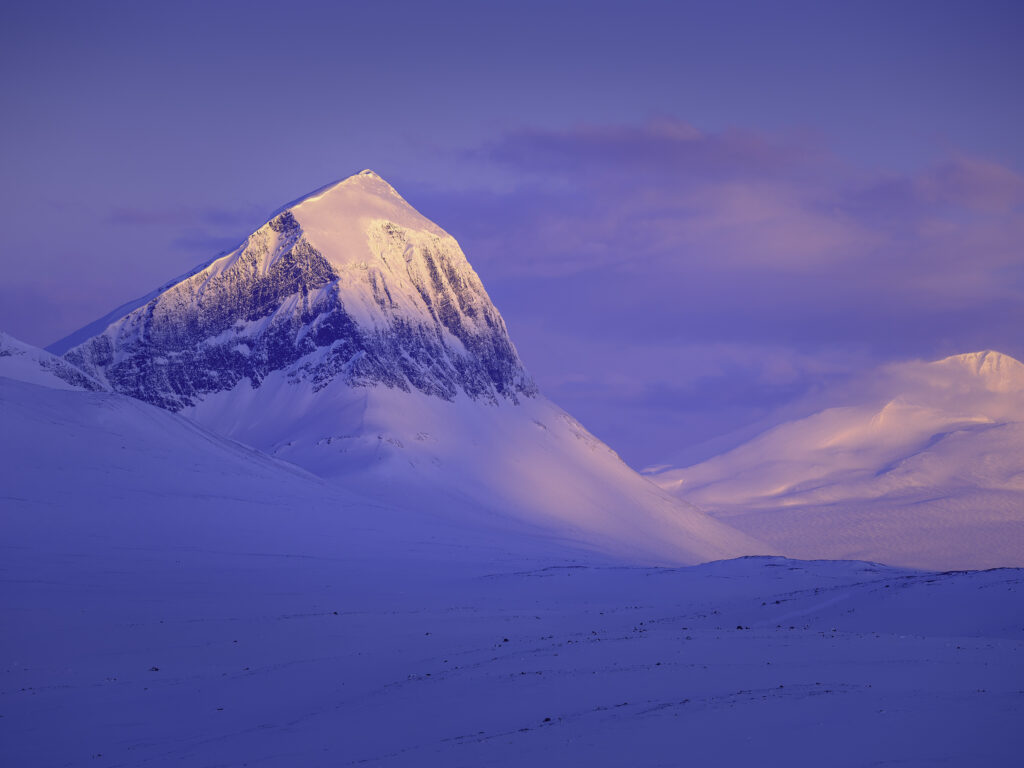 The mountain Niak in Sarek National Park catches the first light on a winter morning.