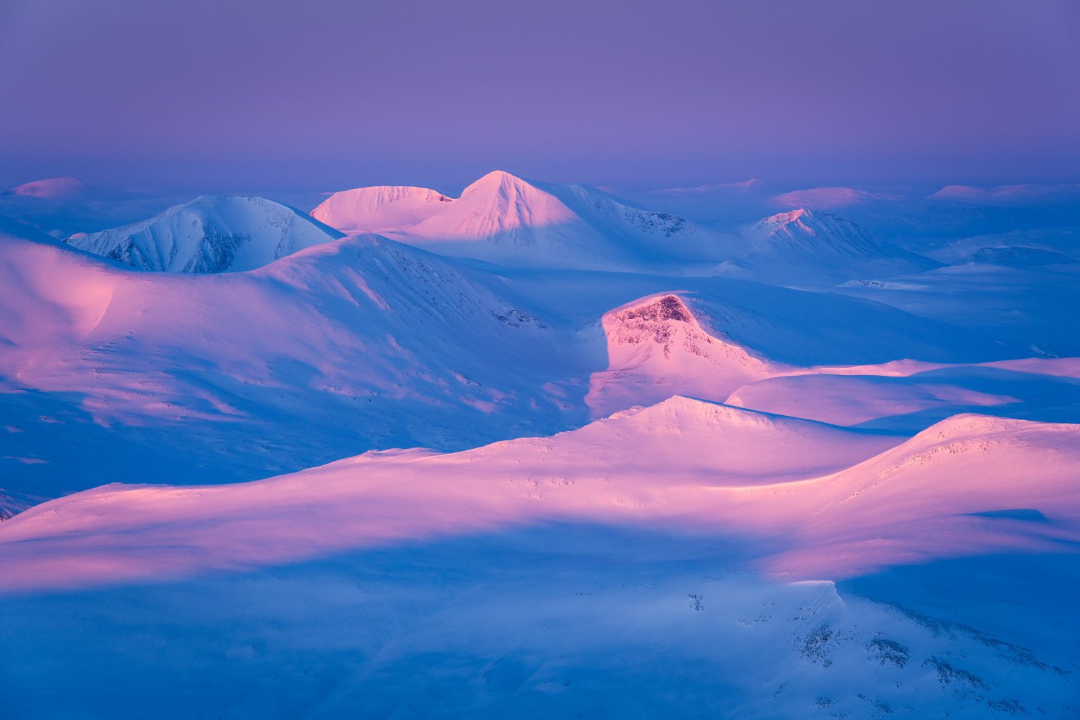 Sunrise over the winter mountains of Sarek and Staika.
