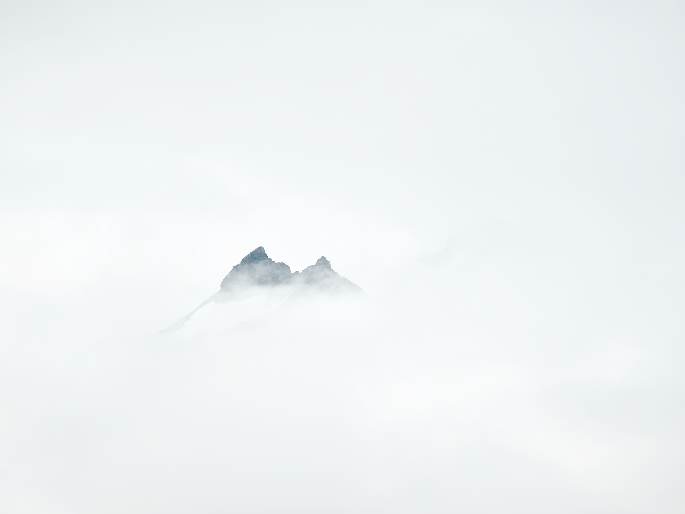 The mountains of Ähpar barely visible through low clouds.