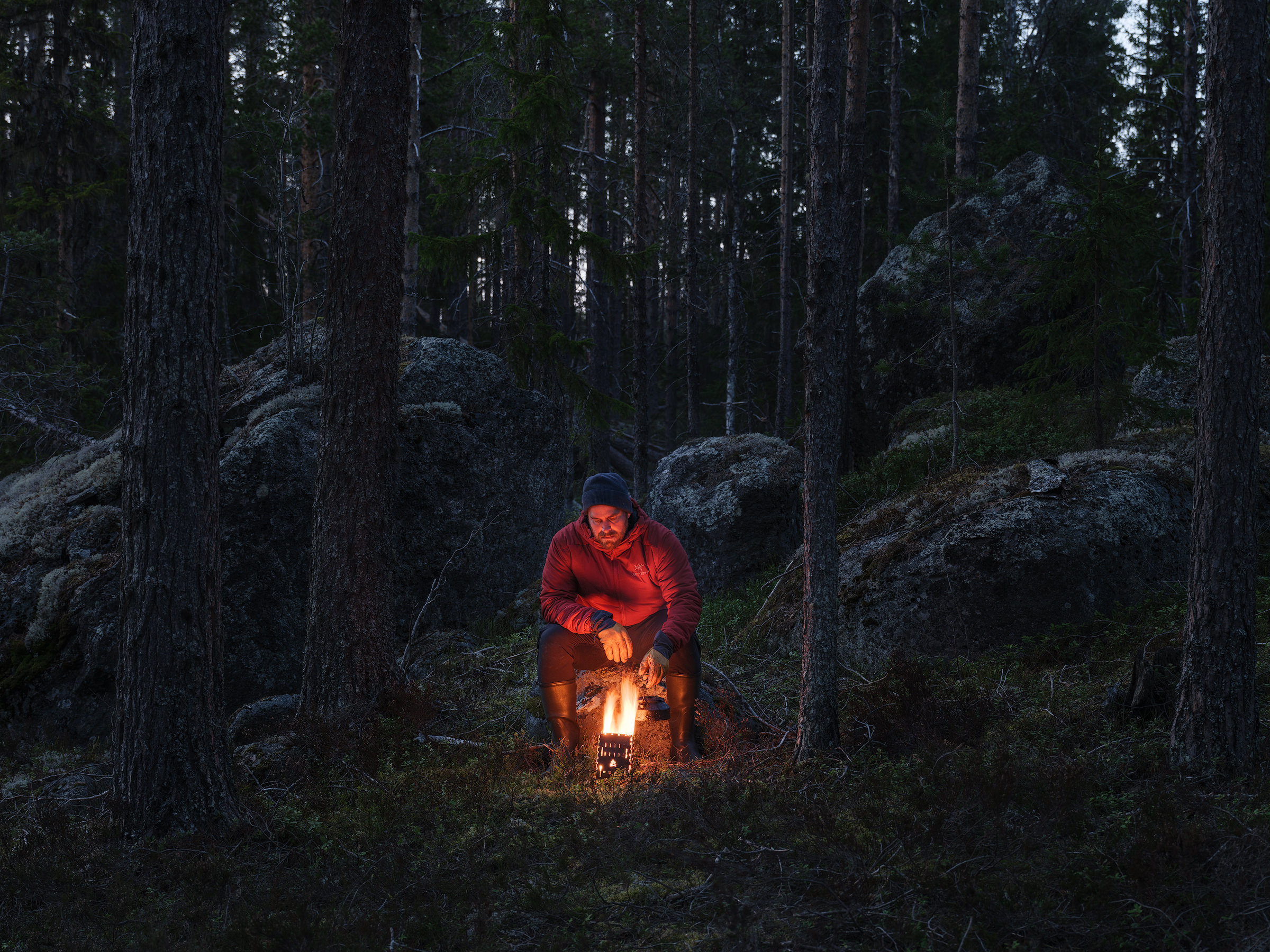 Magnus Lindbom is making a cup of coffee on his wood stove in Helvetesbrännans Nature Reserve, Jämtland.